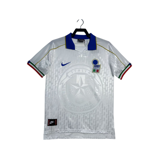 White sports jersey with blue and red accents on a hanger against a white background