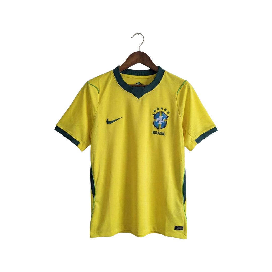 Yellow soccer jersey with green accents on a hanger against a white background