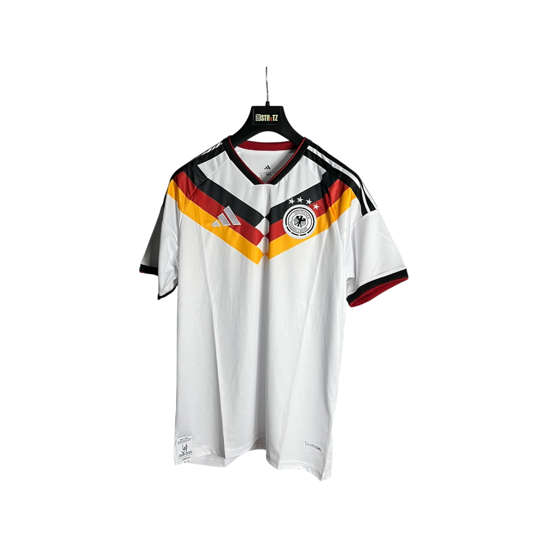 White sports jersey with black, red, and yellow design on a hanger against a white background