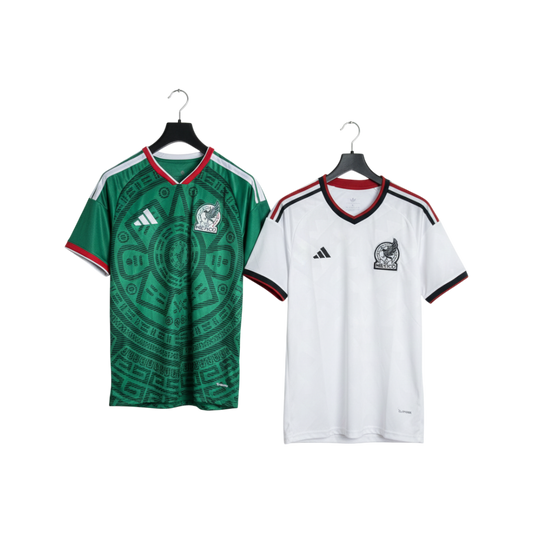 Green and white sports jerseys on hangers with Adidas logo.