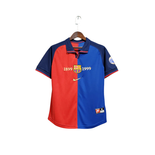 FC Barcelona 1999/2000 Home Jersey displayed on a hanger, with the iconic red and blue colors and Nike logo visible.
