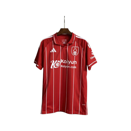 Red sports jersey with white stripes and branding on a hanger against a white background