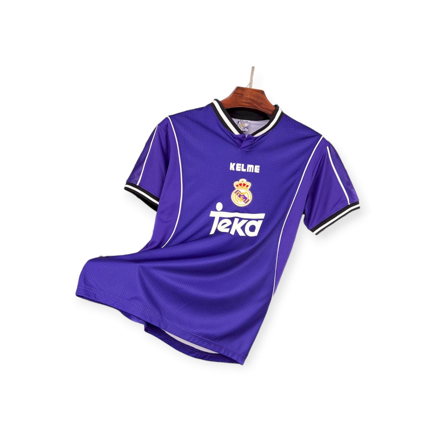 A purple Real Madrid third jersey from the 1997/1998 season, displayed on a hanger.