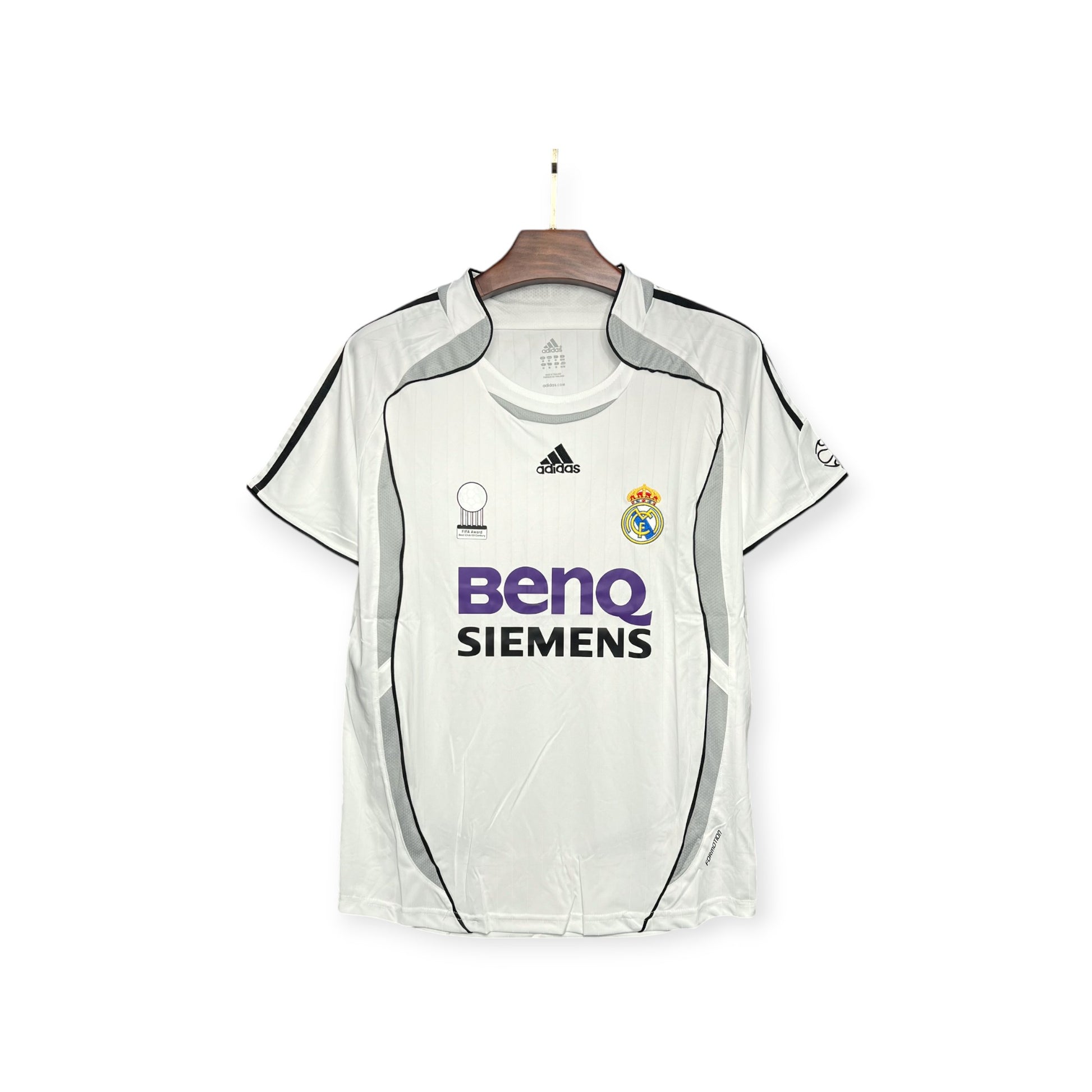 Real Madrid 2006/2007 Home Jersey displayed on a hanger, predominantly white with black and gray accents, featuring the Adidas logo and BenQ Siemens sponsor branding.