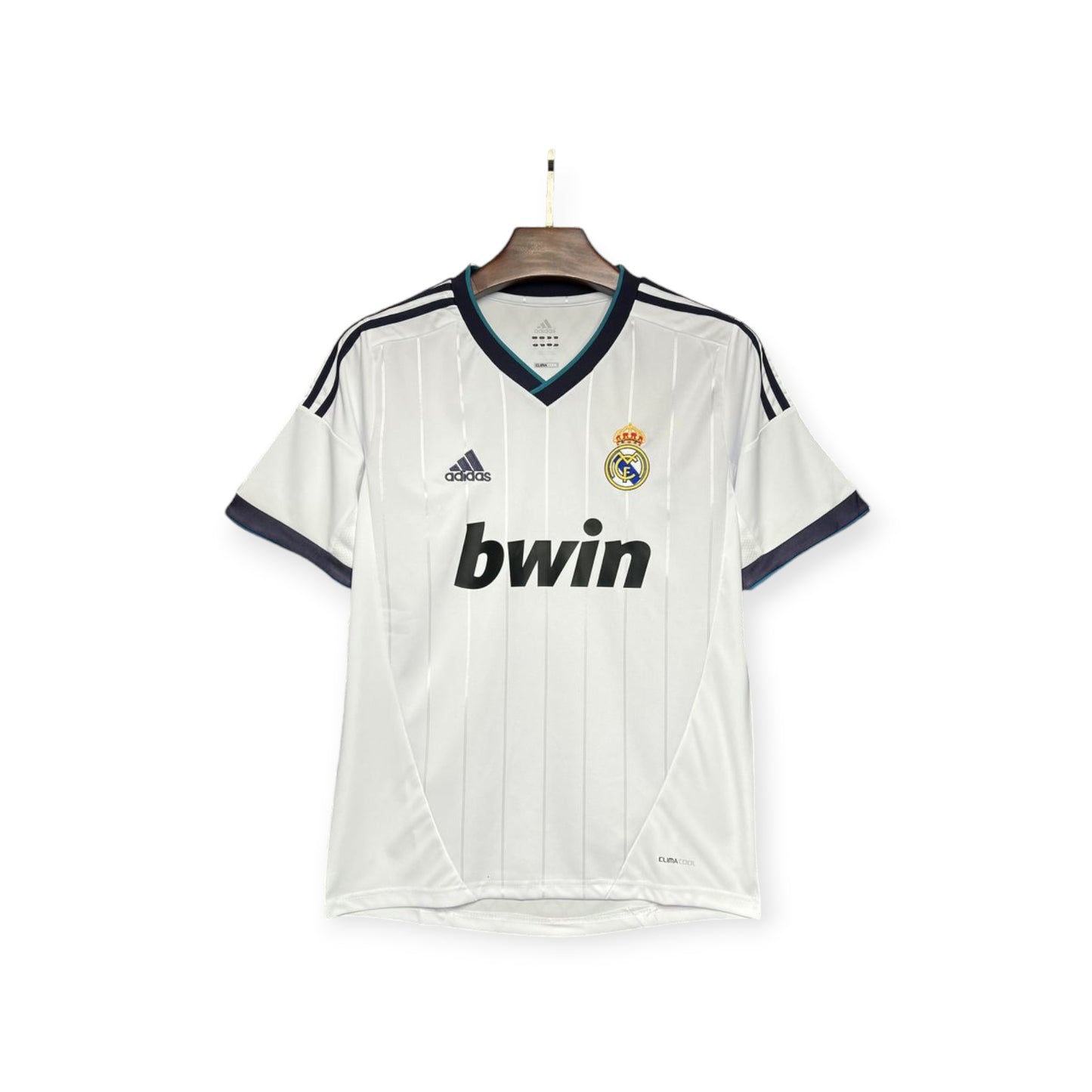 Real Madrid 2012/2013 Home Jersey displayed on a mannequin, featuring white color with blue and black accents, the club crest, and the bwin sponsor logo.