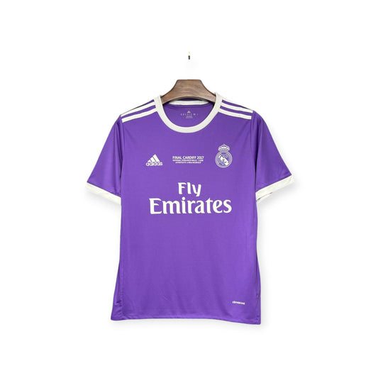 Real Madrid 2016/2017 Away Jersey displayed on a mannequin, featuring a purple color with white stripes and the Fly Emirates sponsor logo.